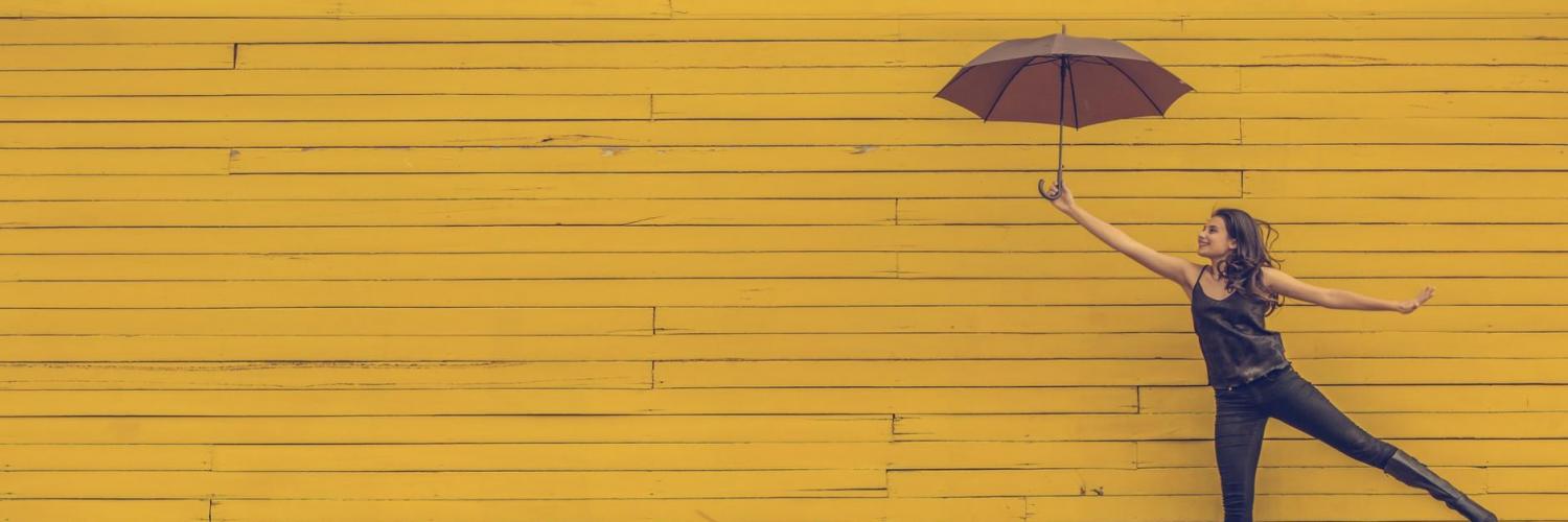 Yellow wall and woman with an umbrella