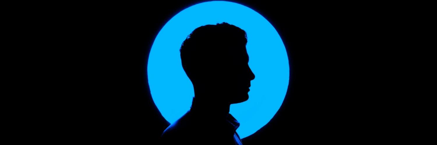 Person in the dark with blue circle