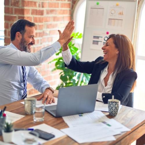 man and womand high five in the office