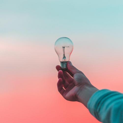 Light bulb with pink and blue sky