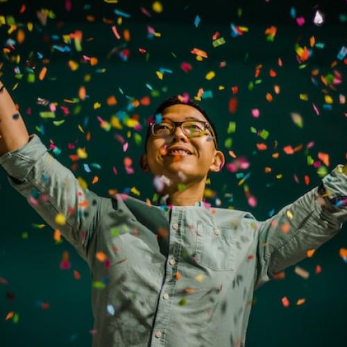 Man celebrating by throwing confetti in the air 2 