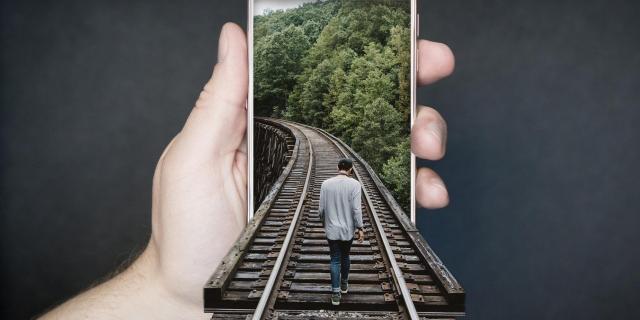 MAN WALKING ON TRAIN TRACK