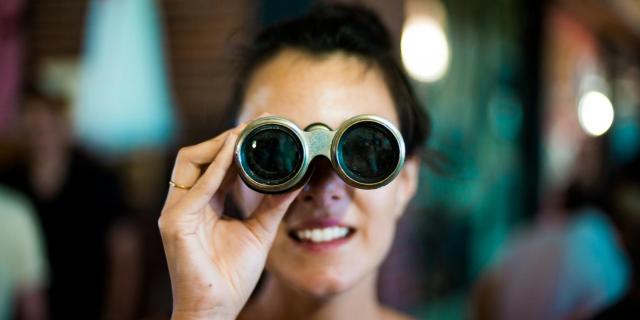 woman holding binoculars