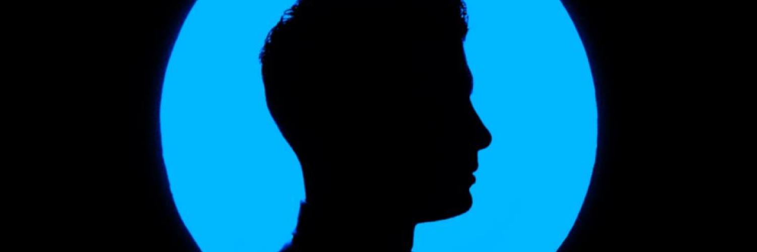 Person in the dark with blue circle Person in the dark with blue circle